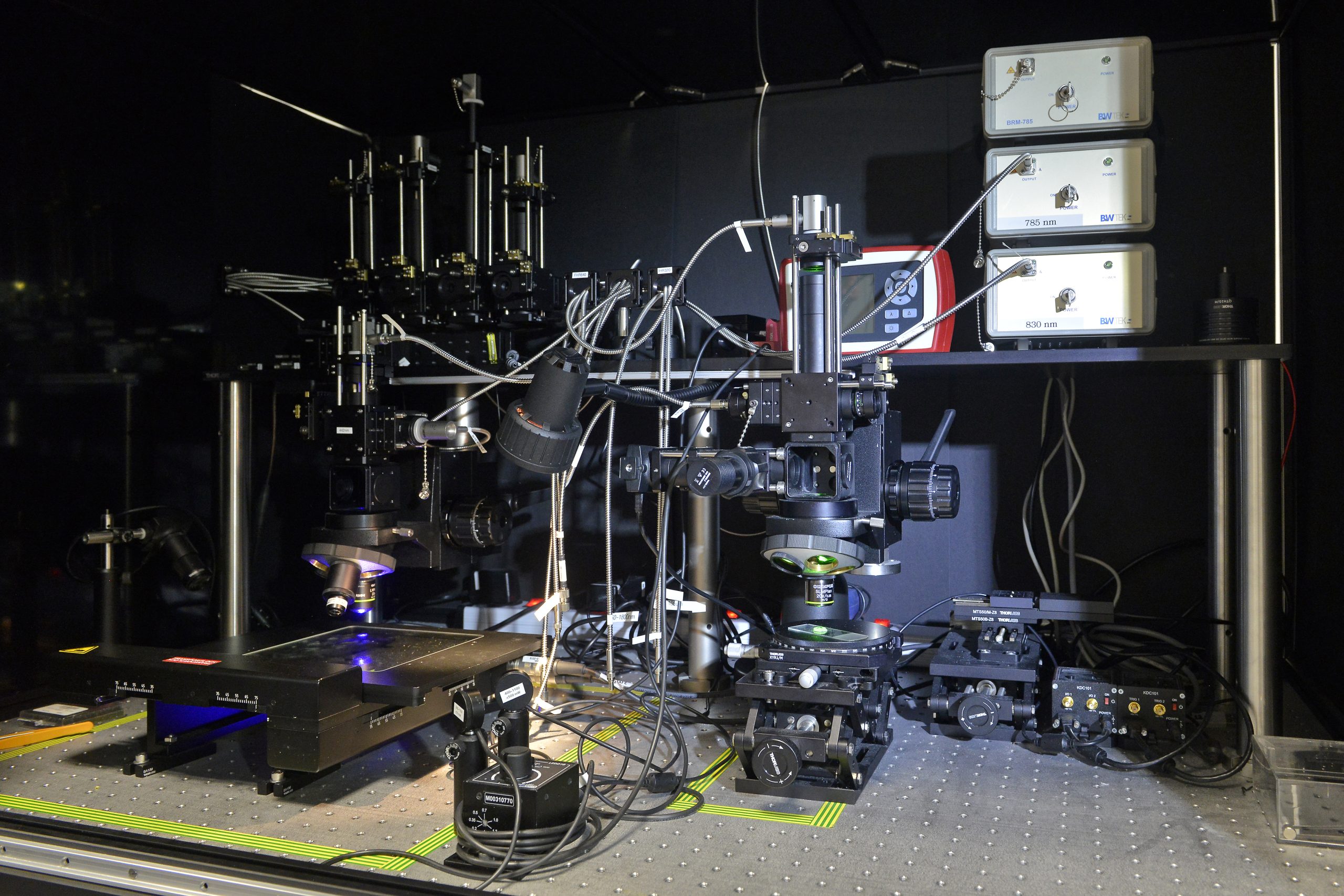 Laboratory instrument display showing department and company information, representing organized research infrastructure in solar energy materials and device development