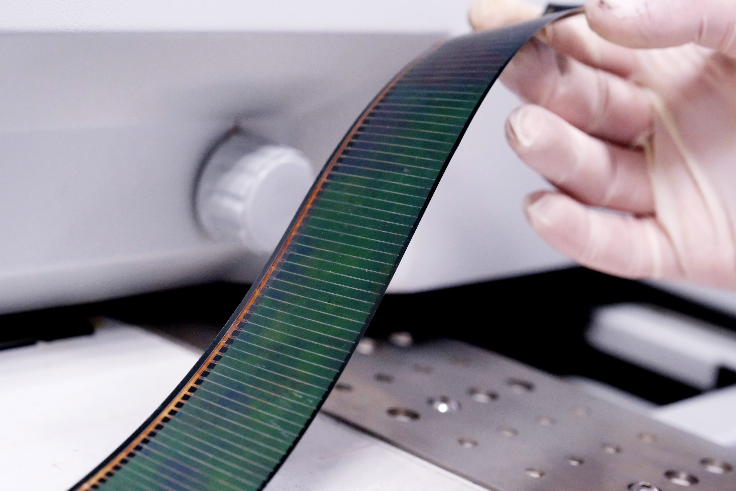 Strip-like laboratory sensor band representing flexible monitoring systems and multisensor metrology tools used for real-time data acquisition and photovoltaic process analysis.