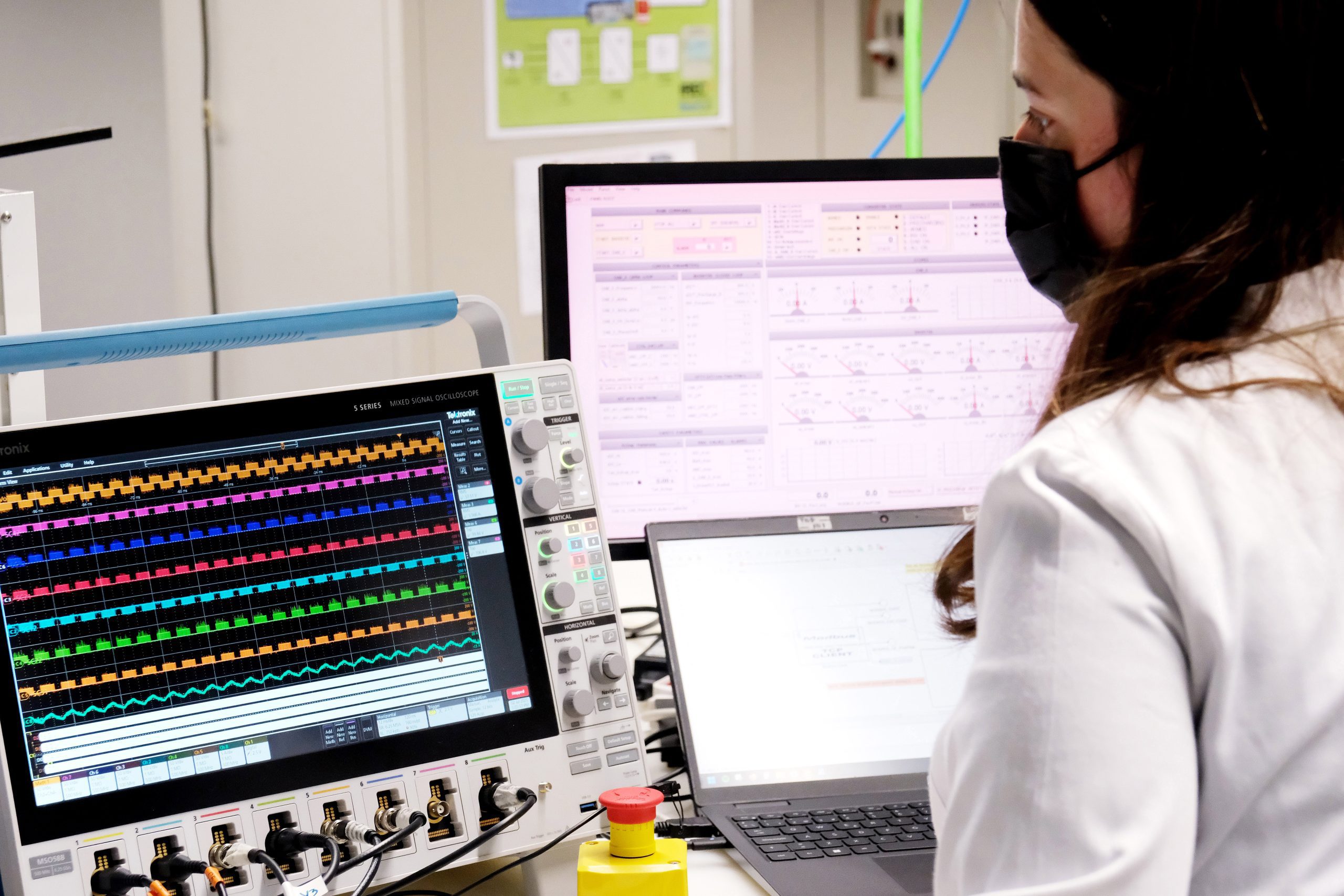 Energy researcher analysing electrical oscillations on a computer in a renewable energy laboratory focused on offshore wind integration, grid stability and large-scale power system innovation.