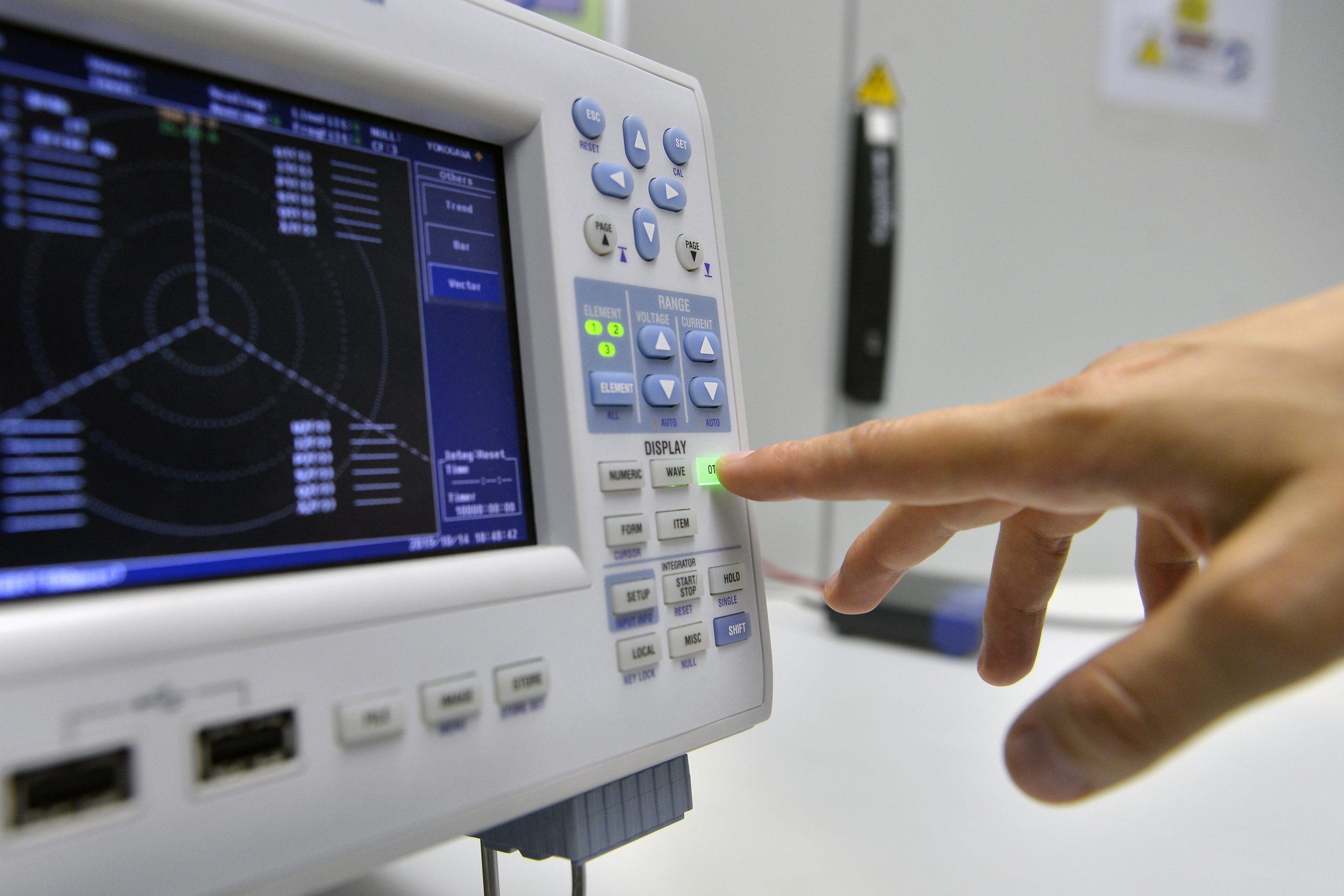 Advanced energy research laboratory equipment displaying electrical waveforms with voltage and current control for smart grid testing, power electronics analysis and renewable energy system monitoring.