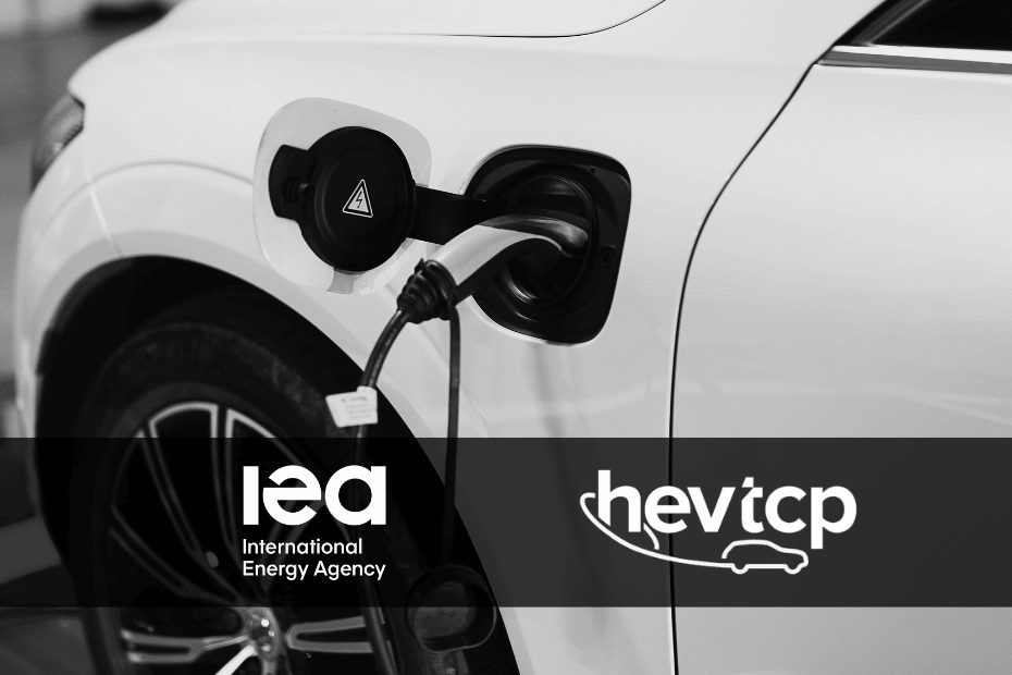 Close-up of a white electric vehicle being charged, with the IEA and HEV-TCP logos overlaid at the bottom.