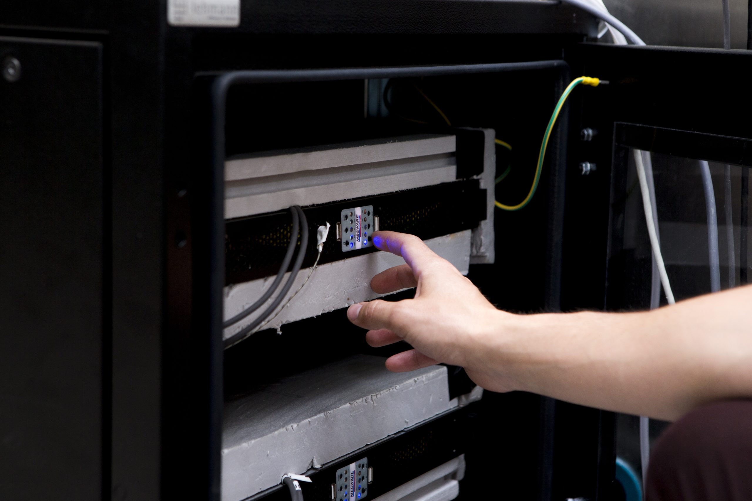 Researcher adjusting laboratory machine for building energy efficiency measurements, indoor comfort analysis and validation of energy performance models.