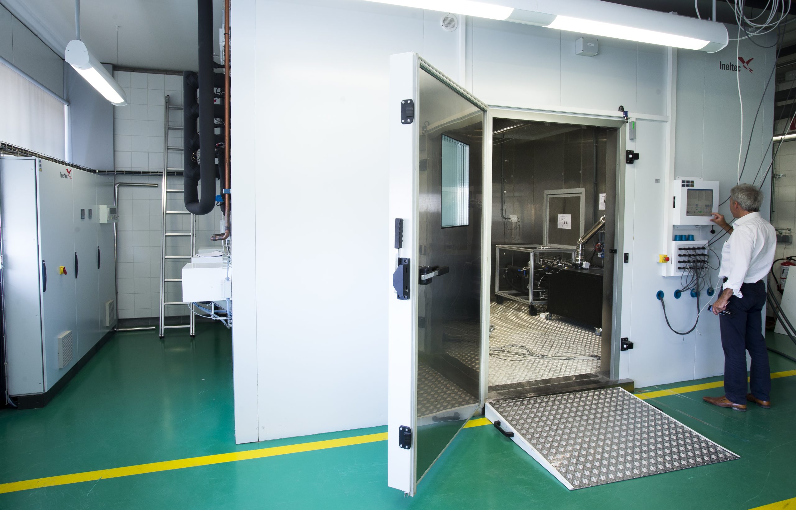 Researcher adjusting laboratory machinery used for energy system modelling, decarbonisation analysis and evaluation of large-scale building retrofit strategies.