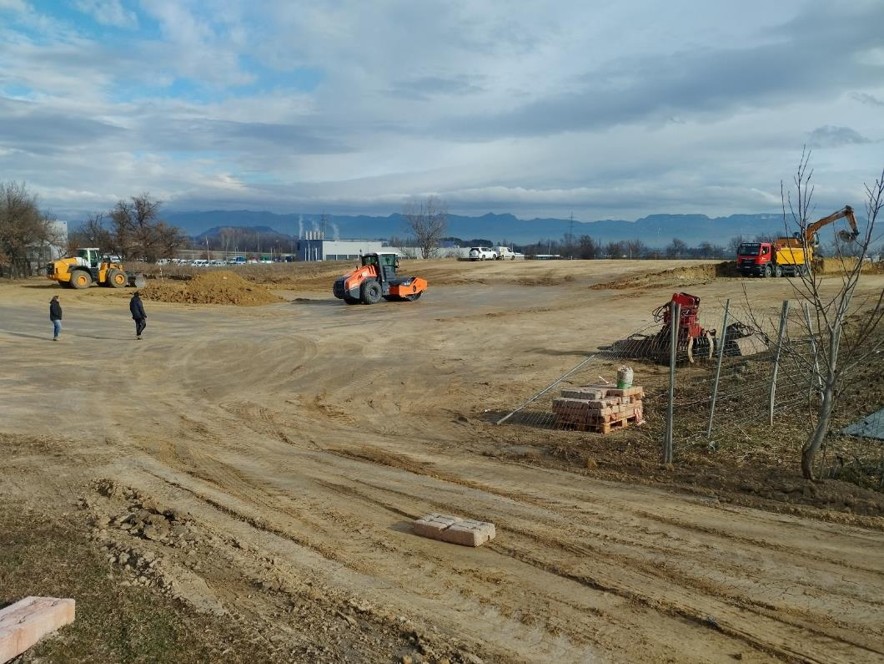 Construction site with earthworks and heavy machinery operating on site